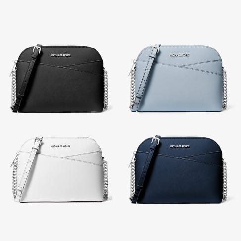 Four Michael Kors shoulder bags in black, light blue, white, and navy.