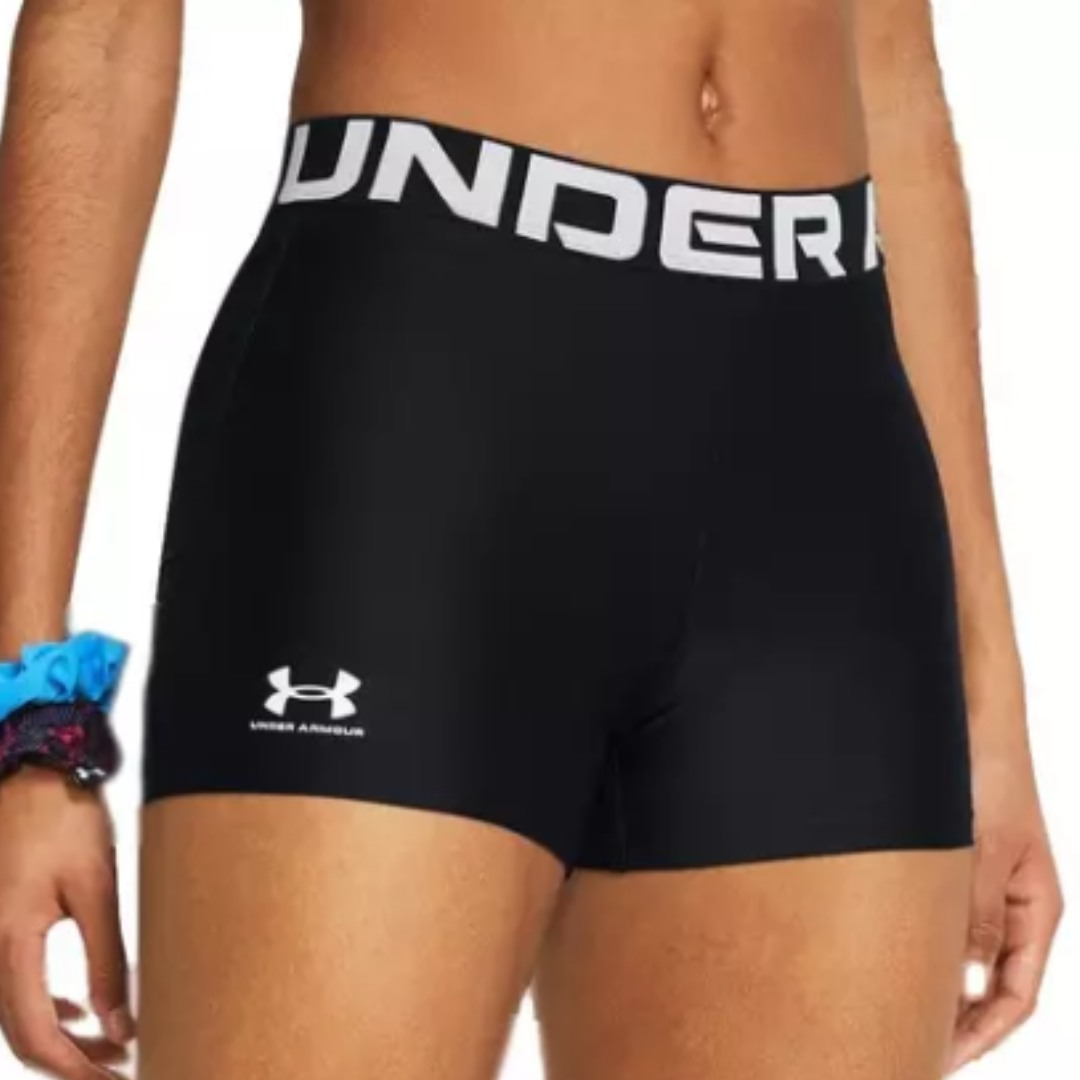 Black Under Armour compression shorts with a wide waistband featuring the brand's name in white. Blue scrunchie on the wrist.