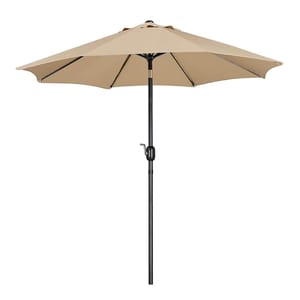 A beige 9-foot patio umbrella with a black metal pole and a manual crank handle for opening and closing.