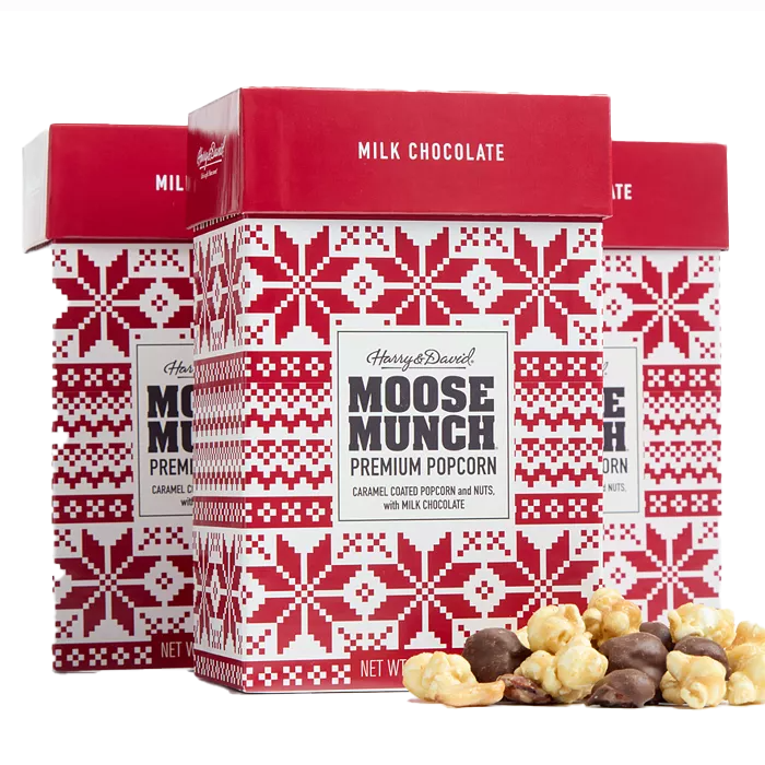 Three boxes of Harry & David Moose Munch Premium Popcorn, featuring caramel-coated popcorn and nuts with milk chocolate, are shown with a Nordic-style red and white design.