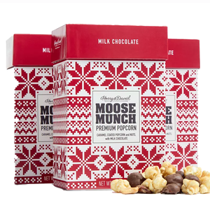 Three boxes of Harry & David Moose Munch Premium Popcorn, featuring caramel-coated popcorn and nuts with milk chocolate, are shown with a Nordic-style red and white design.