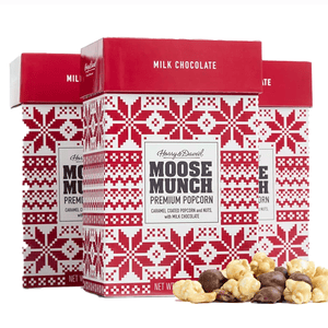 Three boxes of Harry & David Moose Munch Premium Popcorn, featuring caramel-coated popcorn and nuts with milk chocolate, are shown with a Nordic-style red and white design.