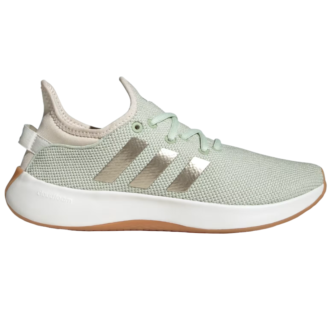 Adidas Cloudfoam shoes in a light green color with a mesh upper, metallic three stripes on the sides, and a white sole. The heel has a pull tab, and \“Cloudfoam\“ is embossed on the midsole, designed for comfort and casual wear.