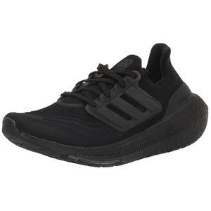Women's Adidas Ultraboost shoes in black feature a knit upper, cushioned midsole, and signature three-stripe design on the side, offering comfort and support for athletic activities.