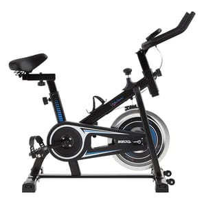 A black indoor exercise bike with a cushioned seat, adjustable handlebars, and a flywheel for resistance, featuring foot straps on the pedals. The bike includes a water bottle holder and displays blue accents on its frame.