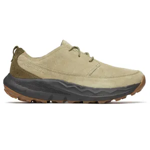 A tan suede shoe with a black, rugged sole, suitable for outdoor activities. The design includes a lace-up closure and a textured outsole for grip.