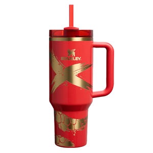 A red 40oz Stanley Lunar New Year Tumbler featuring a bold gold \“X\“ design, gold accents, and a handle, complete with a matching red straw.