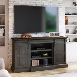 A flat-screen TV mounted above a wooden TV stand with cabinets, hosting various electronic devices and decorative items.