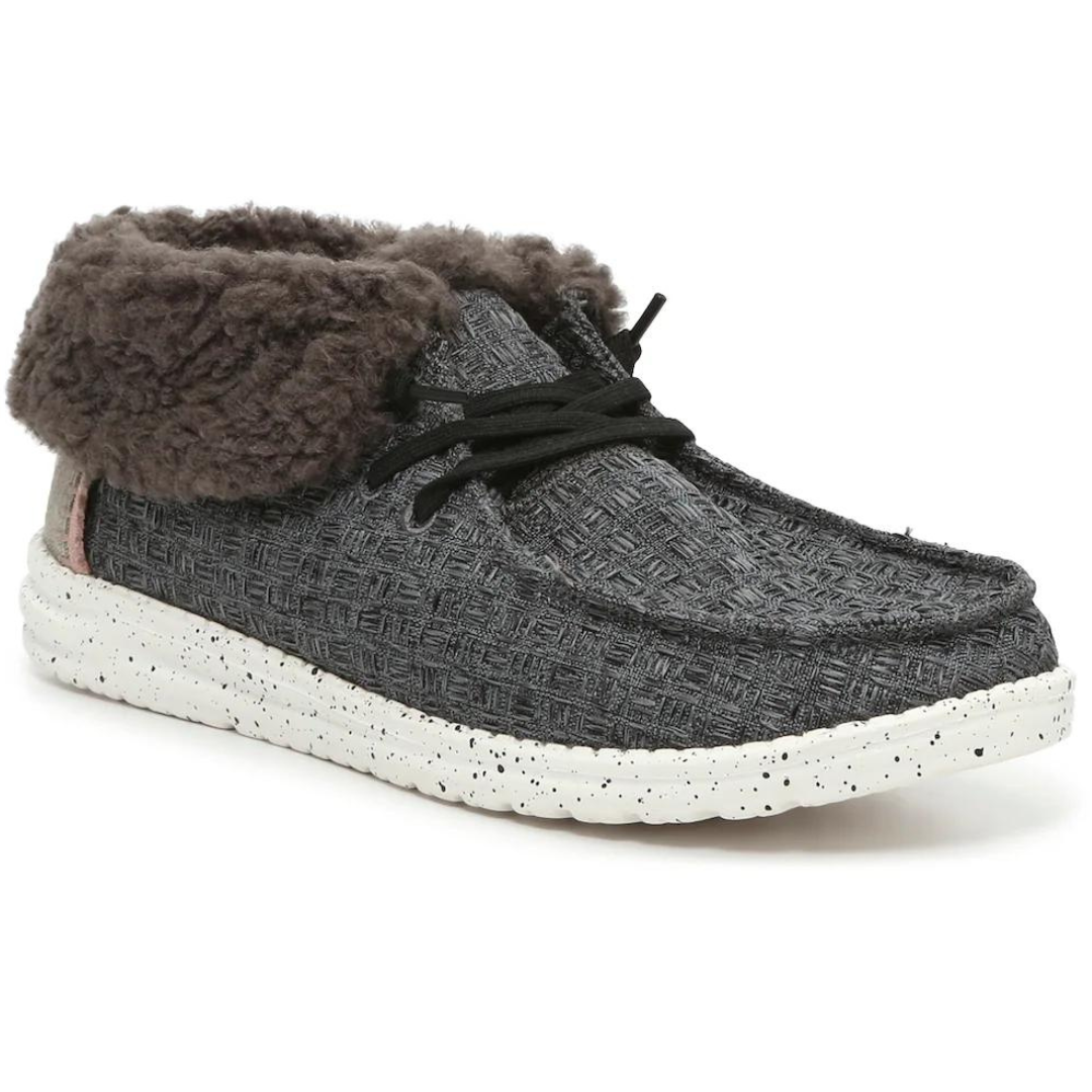 A gray textured shoe with a furry cuff and black laces on a speckled white sole.