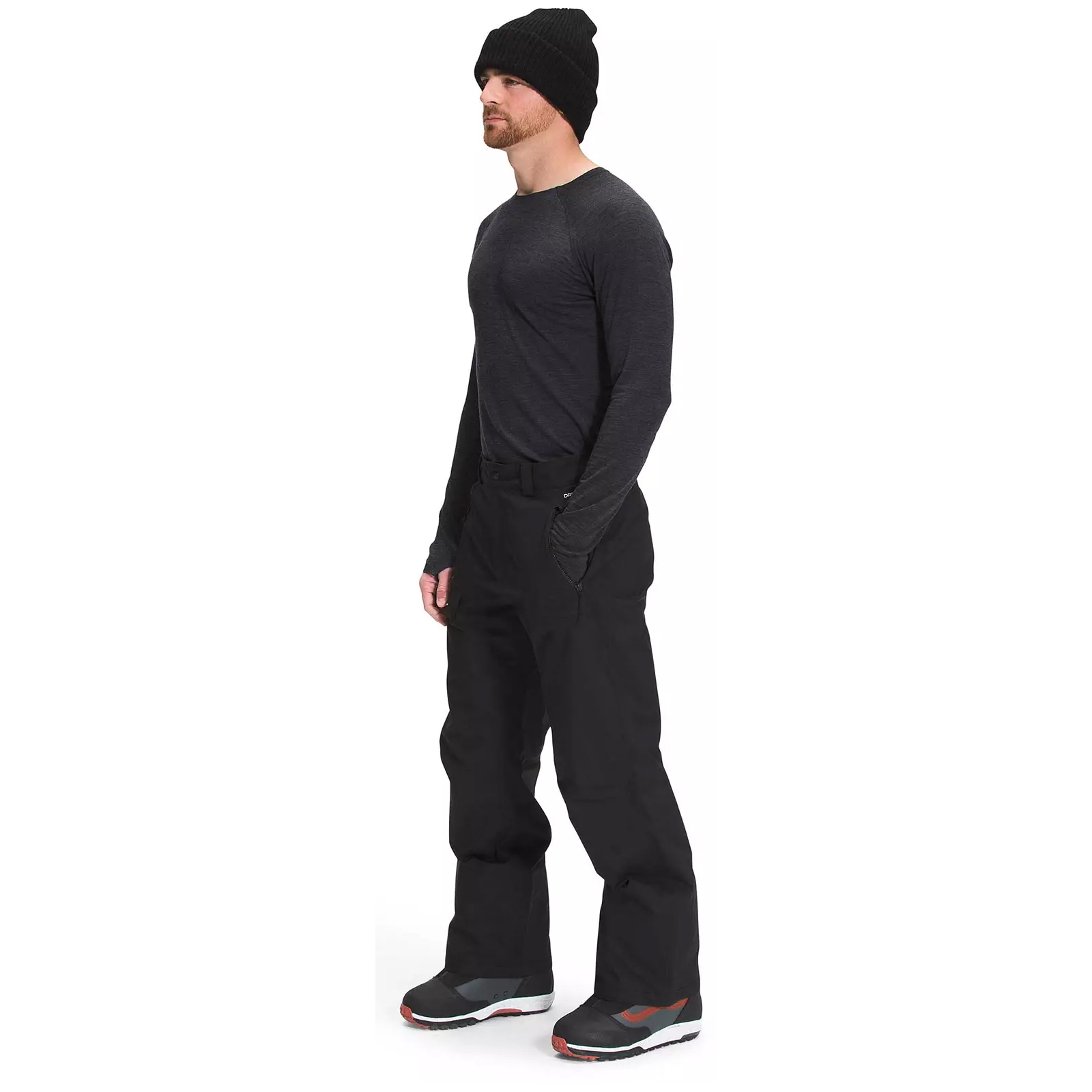 Black North Face ski pants with a relaxed fit, featuring belt loops and pockets. The pants are paired with black boots and a dark long-sleeve shirt, suitable for cold weather activities.
