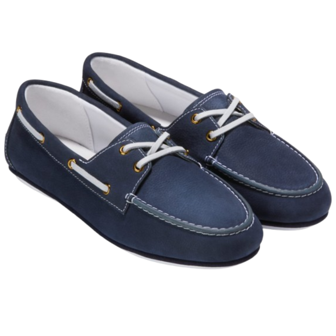 A pair of navy blue boat shoes with white laces and gold eyelets, featuring white stitching and a slip-on design.