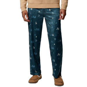 Teal pajama pants with a winter-themed pattern featuring snow-covered tents, trees, and deer, paired with brown slippers.