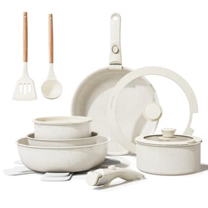 The 17-piece Bazova Cookware Set includes a frying pan, a saucepan with lid, three stackable pots, two cooking utensils, a detachable handle, and protective pads. The cookware is cream-colored with a speckled design.
