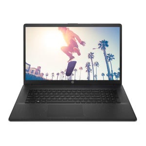 A laptop displaying a wallpaper of a person skateboarding against a backdrop of palm trees and a sunlit sky.