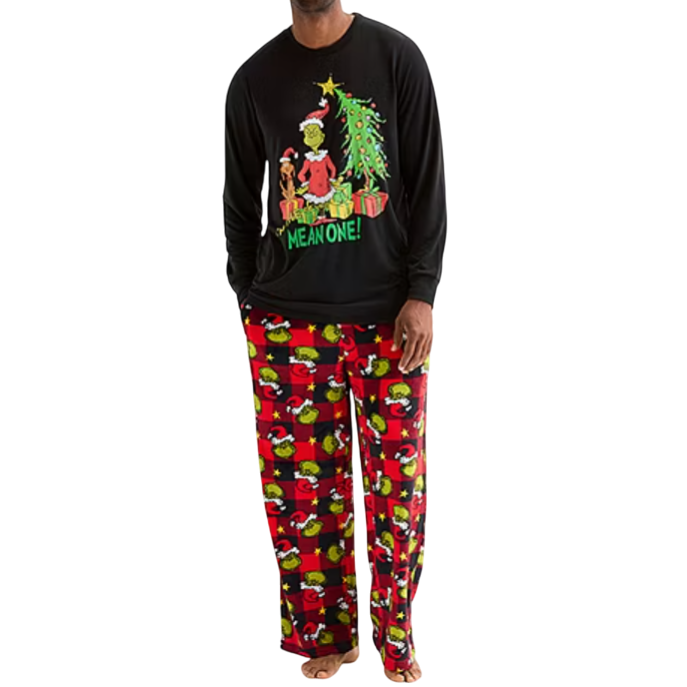 A man is wearing a black long-sleeve shirt with a Grinch and Christmas tree design, paired with red-and-black checkered pajama pants featuring the Grinch and Max.
