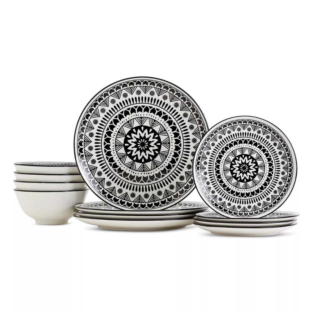 Black and white dinnerware set featuring plates and bowls with intricate geometric patterns.