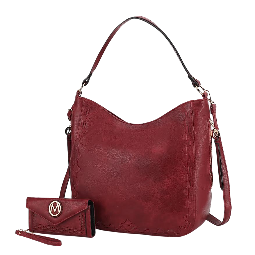A red handbag with a shoulder strap and matching red wallet featuring a decorative logo emblem.