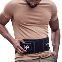 A person is adjusting a black wearable belt with a company logo, designed for back support or muscle recovery, over a beige shirt.