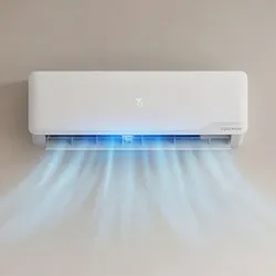 A wall-mounted air conditioner emitting cool air, a gray couch with cushions, a jug of lemon water, and a digital thermometer displaying room temperature are seen in a living room setting.