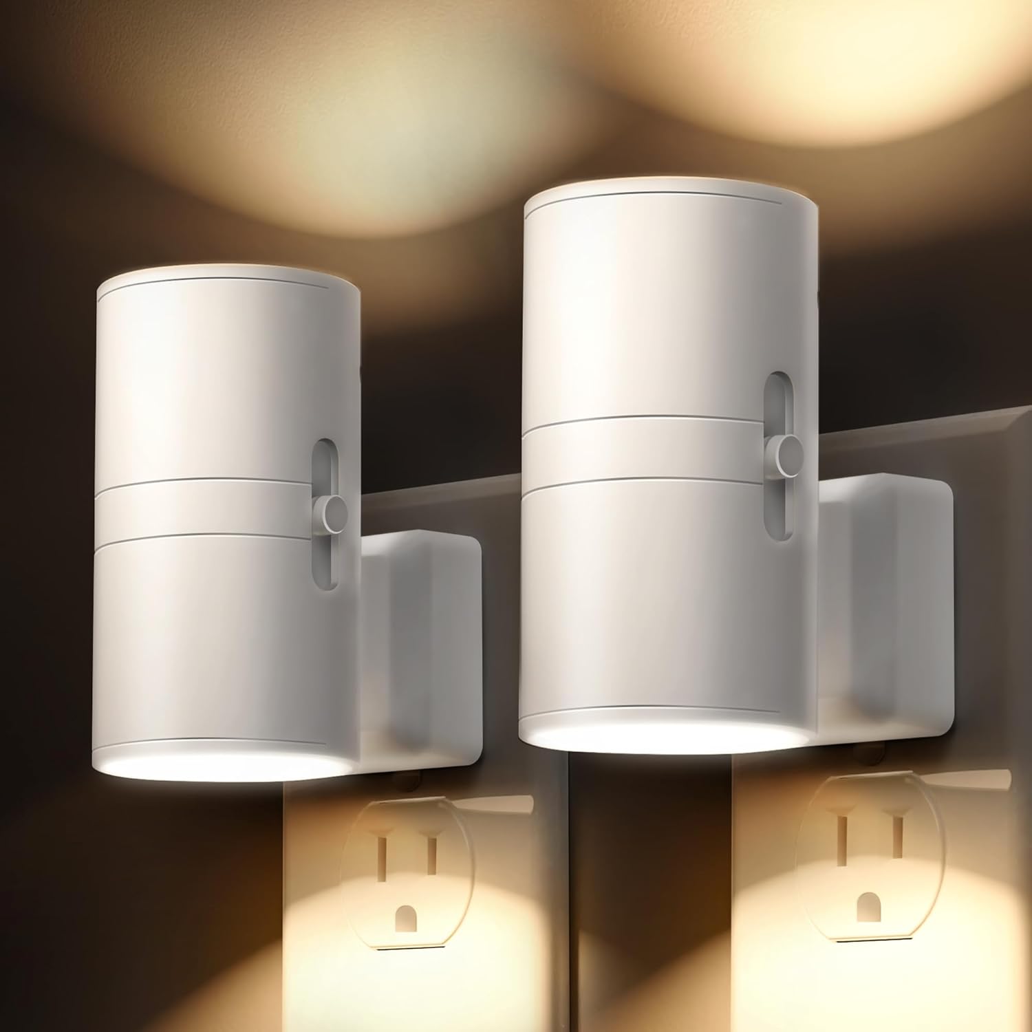 Two white, cylindrical night lights mounted on wall outlets, emitting soft, downward-facing glow.