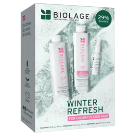 Biolage Winter Refresh set for color-treated hair includes a 13.5 fl oz shampoo, 13.5 fl oz conditioner, and a 1 fl oz repairing spray, offering 29% savings. The packaging highlights 100% recycled plastic and a vegan formula.