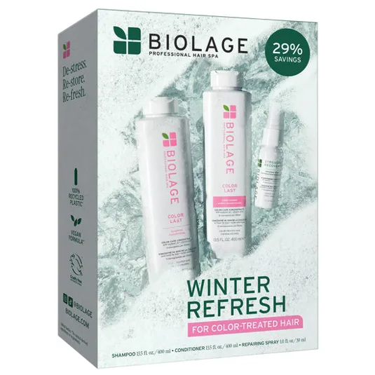 Biolage Winter Refresh set for color-treated hair includes a 13.5 fl oz shampoo, 13.5 fl oz conditioner, and a 1 fl oz repairing spray, offering 29% savings. The packaging highlights 100% recycled plastic and a vegan formula.