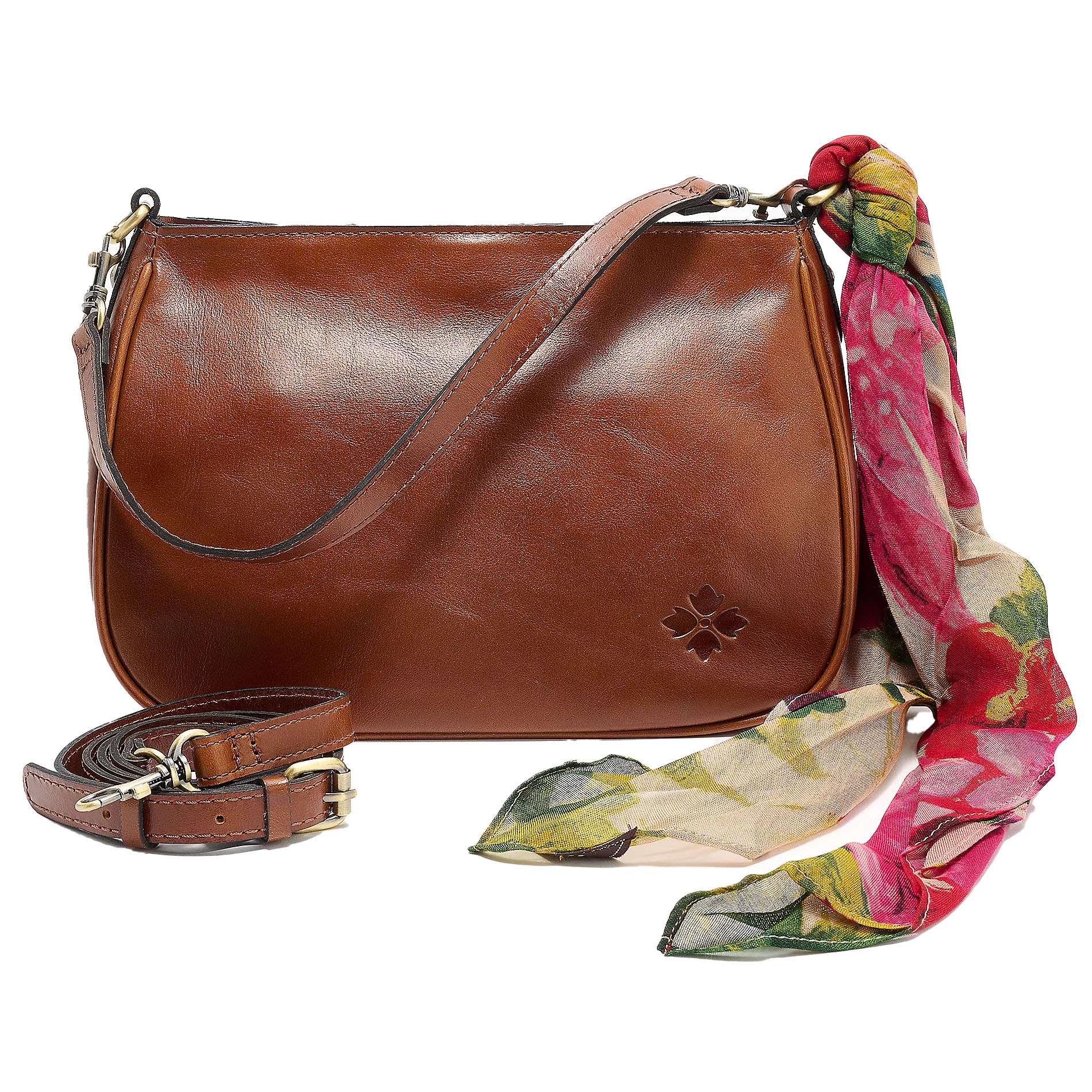 A brown leather shoulder bag with a floral patterned scarf tied at the strap, featuring a small embossed logo, and a detachable strap with brass hardware.