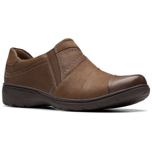 A brown slip-on shoe with a low heel and contrasting stitching, designed for comfort and casual wear.