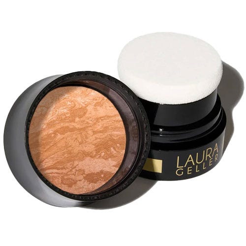 Laura Geller baked blush in a black container with a sponge applicator, featuring a marbled pattern in warm tones.