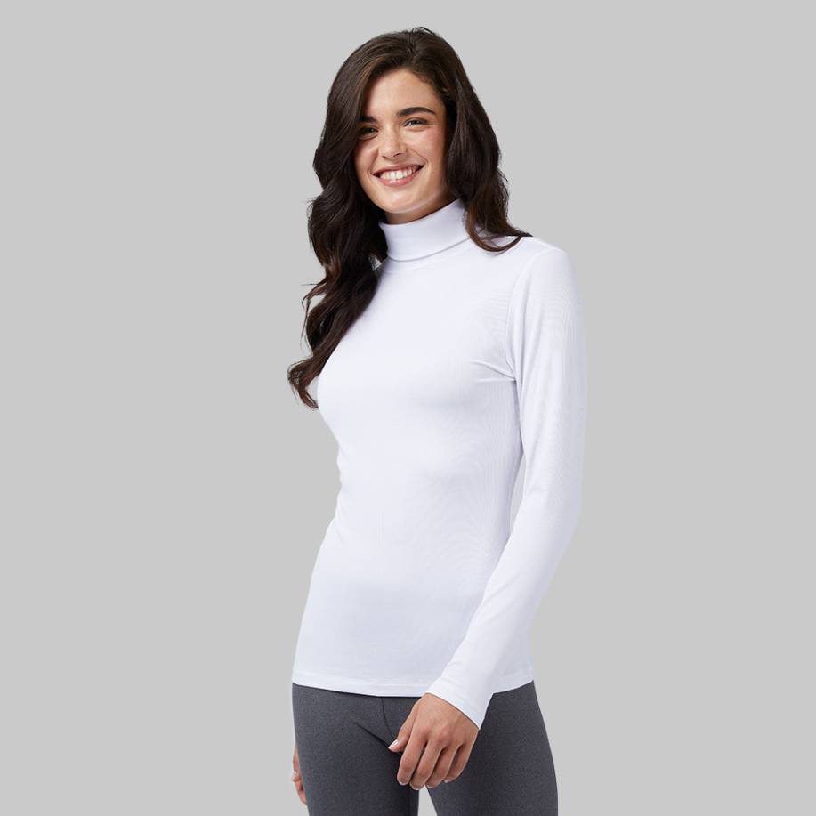 A woman is wearing a white turtleneck long-sleeve top and gray leggings.