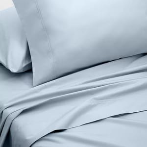A light blue bed sheet set featuring a pillowcase and a flat sheet with a smooth, matte finish.