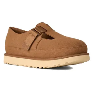 A brown, closed-toe shoe with a thick beige sole, featuring a strap with an adjustable buckle and side cutouts for ventilation.