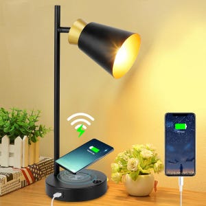 A desk lamp with a built-in wireless charging pad and a space for wired charging of another device.