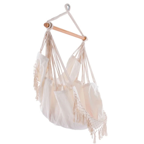 A cream-colored Brazilian hammock chair with fringe details and a wooden spreader bar, designed for hanging and relaxing.