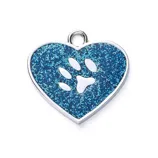 A heart-shaped, blue glitter pet tag features a paw print cutout and a small loop for attachment.