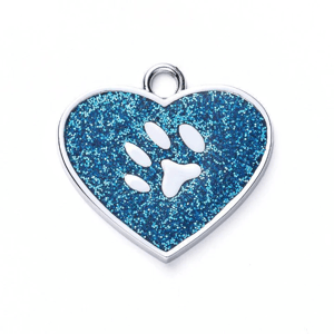 A heart-shaped, blue glitter pet tag features a paw print cutout and a small loop for attachment.