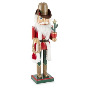 A cowboy-themed nutcracker dressed in a red and white coat with a cowboy hat and boots holds a rope and a cactus with a star on top.