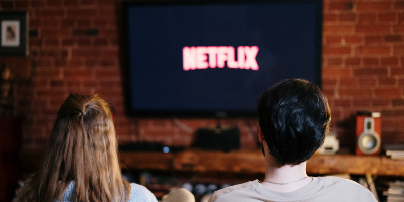 two people in front of tv