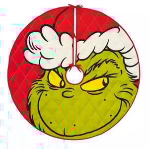 A circular tree skirt featuring the Grinch's face in green with yellow eyes and a red Santa hat on a quilted red background. He appears to be smirking with a mischievous expression.