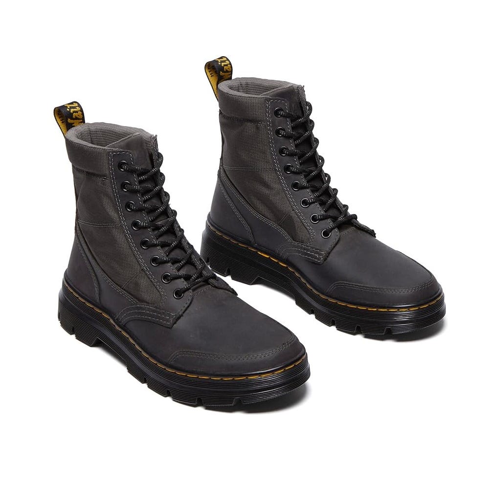 Black lace-up boots with a rugged design, featuring a textured upper, yellow stitching, and a padded collar for comfort.