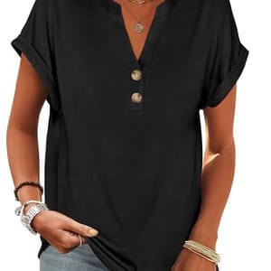 Black short-sleeve blouse with a V-neckline, button details, rolled cuffs, and relaxed fit. Paired with light blue jeans and accessorized with layered necklaces and bracelets.