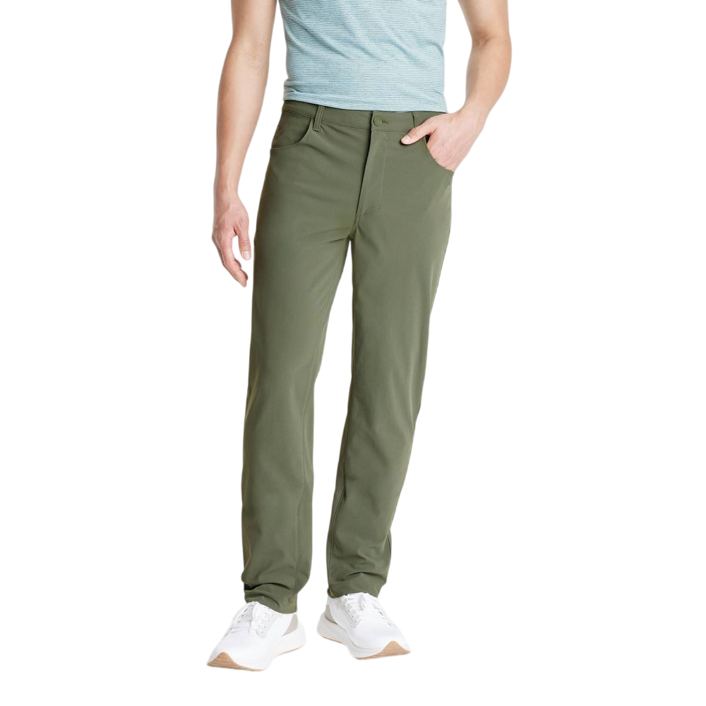 A person is wearing olive green pants paired with a light blue top and white sneakers.