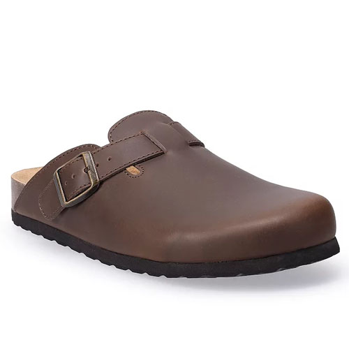 A brown leather clog with a buckle strap and a black sole.