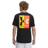 A person is wearing a black T-shirt featuring a colorful graphic design with the Under Armour logo and the text \“Armour\“ on the back.