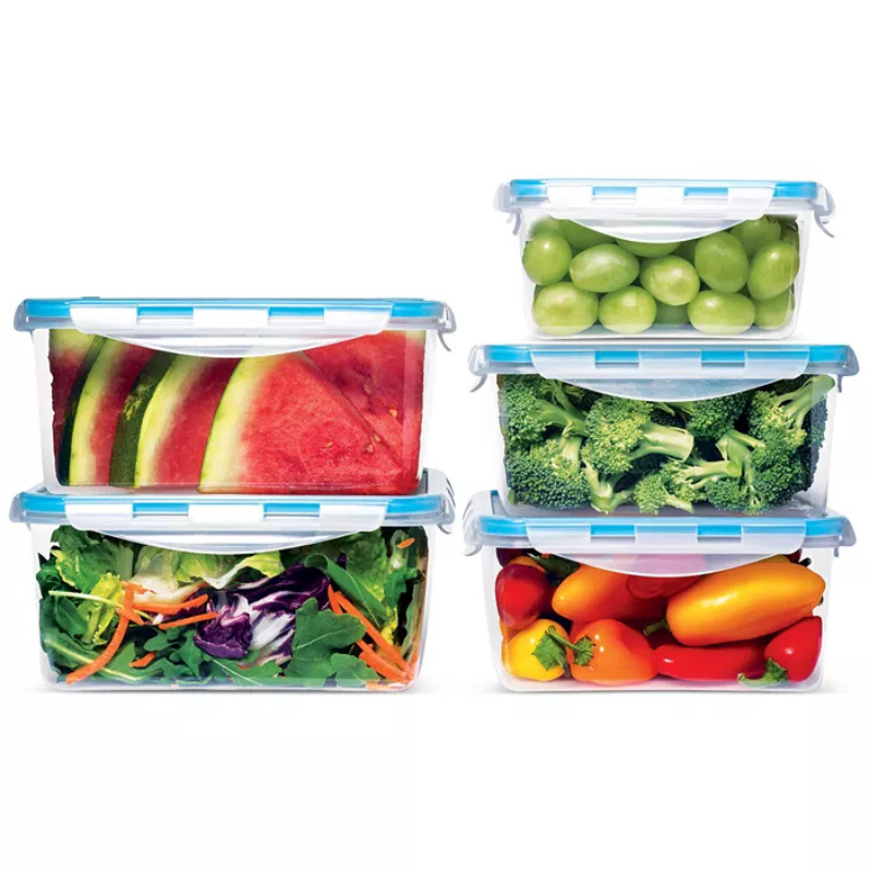 Five clear, rectangular food storage containers with blue lids are shown, each holding different foods: watermelon slices, green grapes, broccoli, a mixed salad, and assorted bell peppers.
