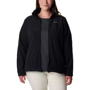 A woman wearing a black Columbia fleece jacket with a front zipper over a dark gray shirt and light pants.