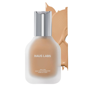 Haus Labs Triclone Skin Tech Foundation is a liquid foundation in a matte glass bottle with a silver cap, designed to provide smooth coverage. It's shown in a medium beige shade.