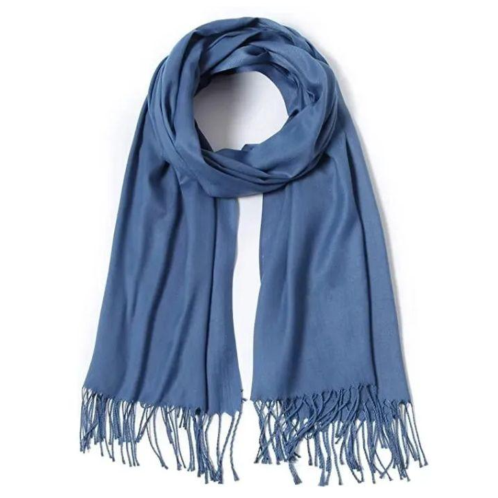 A blue pashmina scarf with a smooth texture and fringed ends. The scarf is elegantly draped in a circular shape.