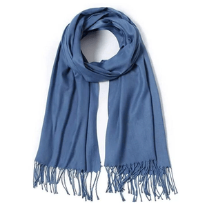 A blue pashmina scarf with a smooth texture and fringed ends. The scarf is elegantly draped in a circular shape.