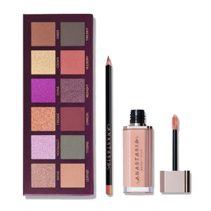 Anastasia Beverly Hills makeup set featuring an eyeshadow palette with 12 shades, a nude lip gloss, and a lip liner in a complementary shade.